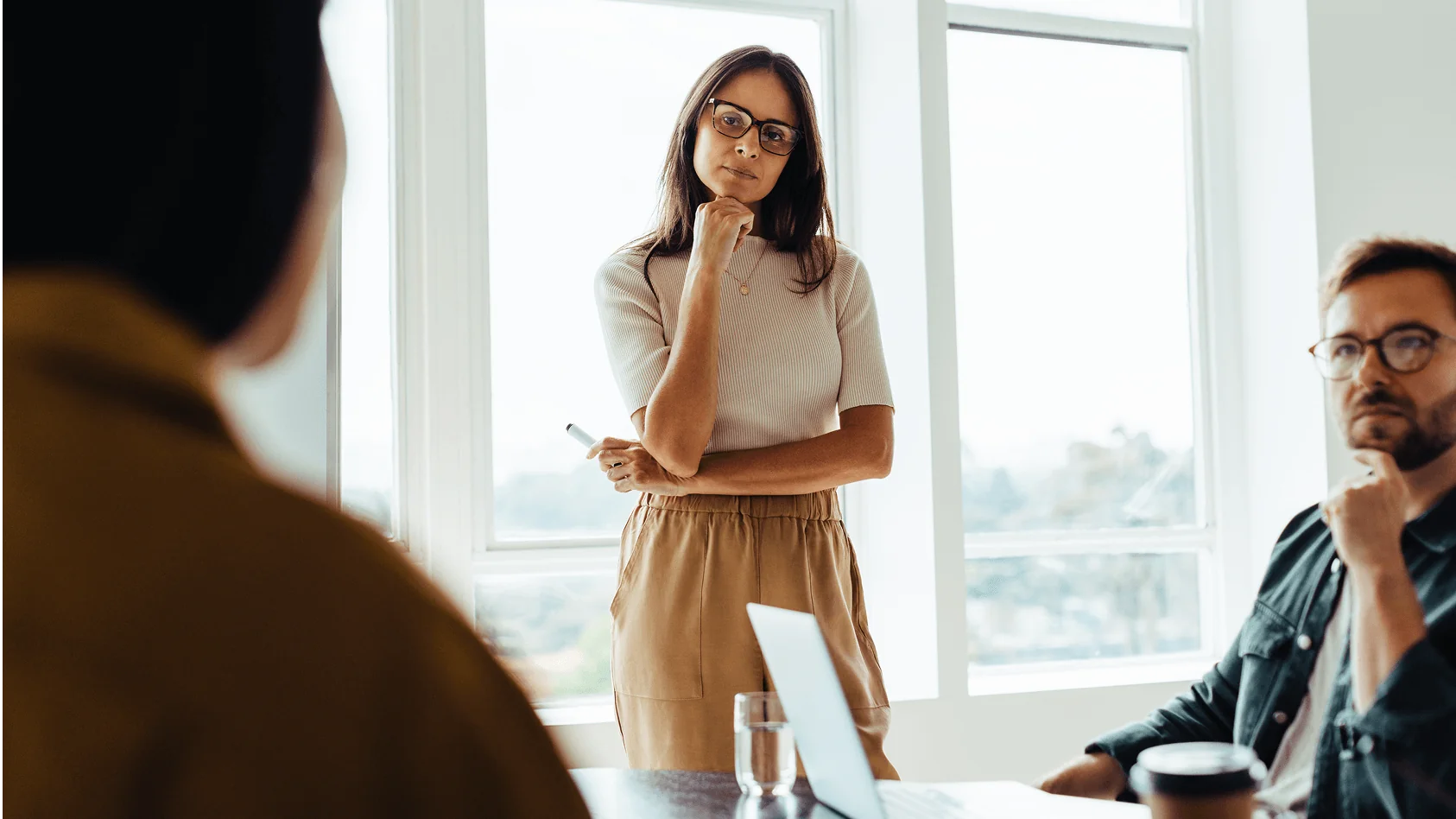 Team members engaged in thoughtful discussion during a meeting