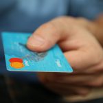 Man holding a debit card.