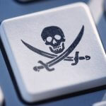 A computer keyboard with the online piracy symbol on one of its buttons.