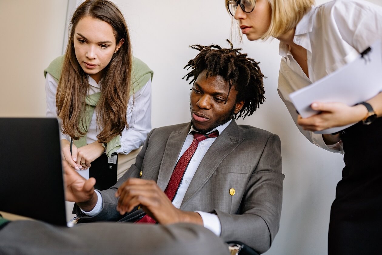 business people discussing infront of a laptop