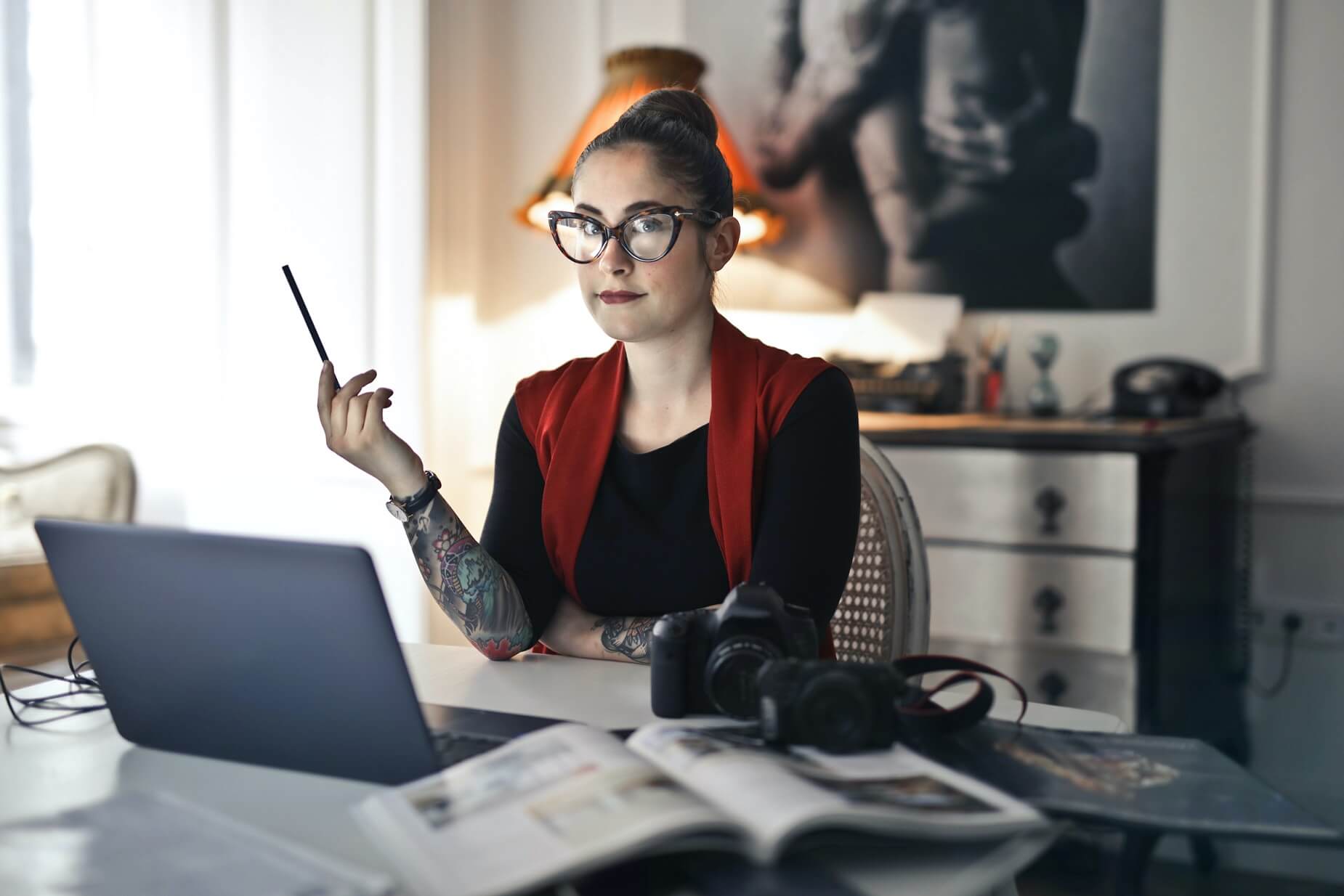 woman with tattoo and laptop
