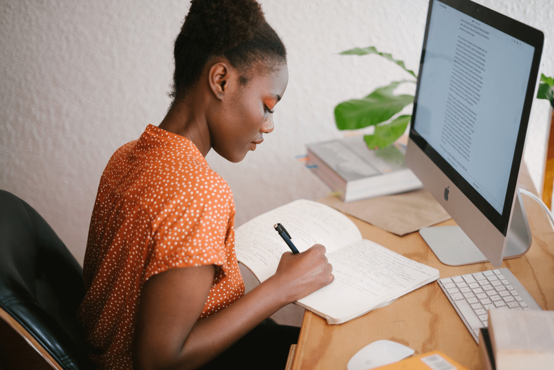 Picture showing a young girl taking notes from online study material