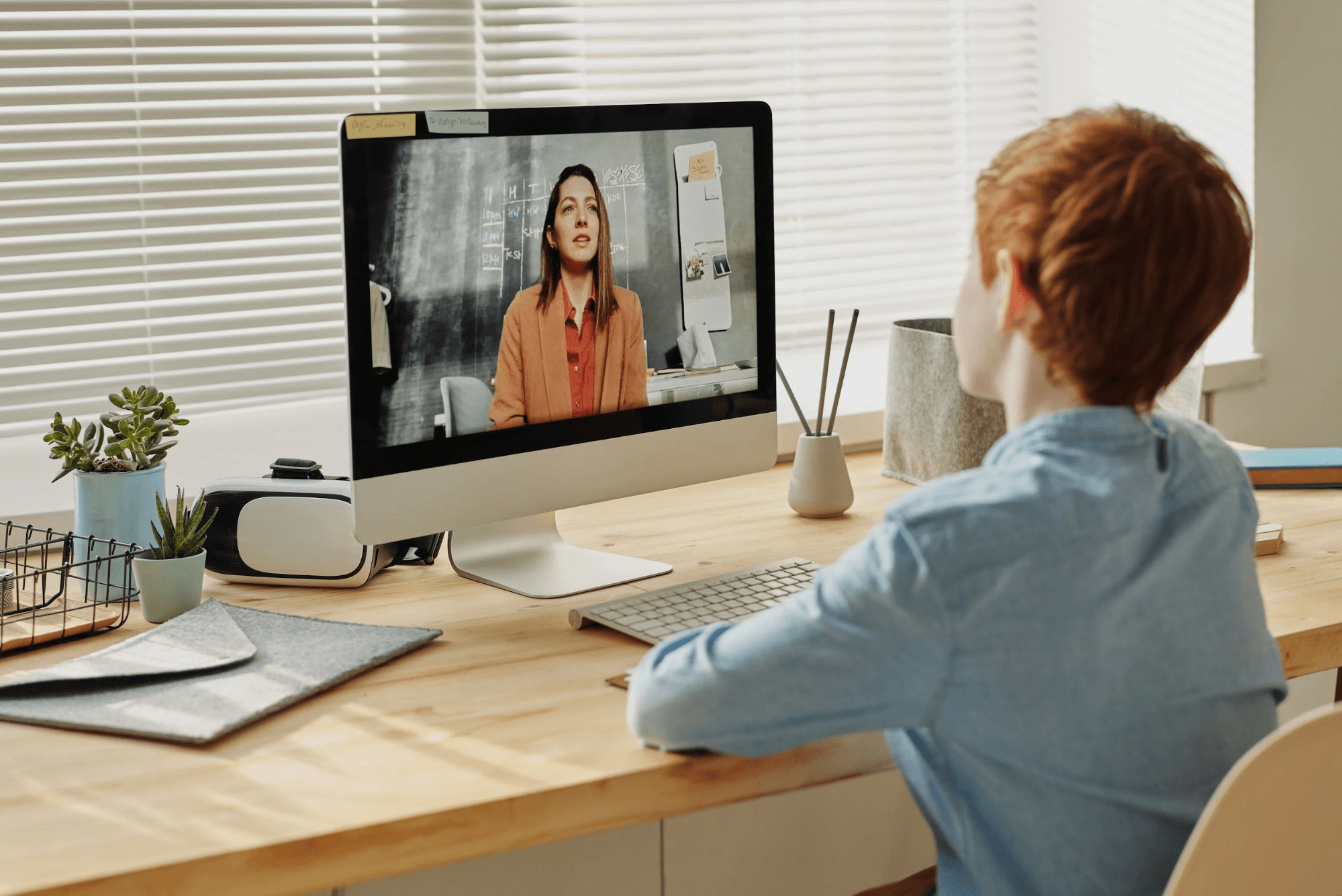 Picture showing a kid participating in a webinar through his PC