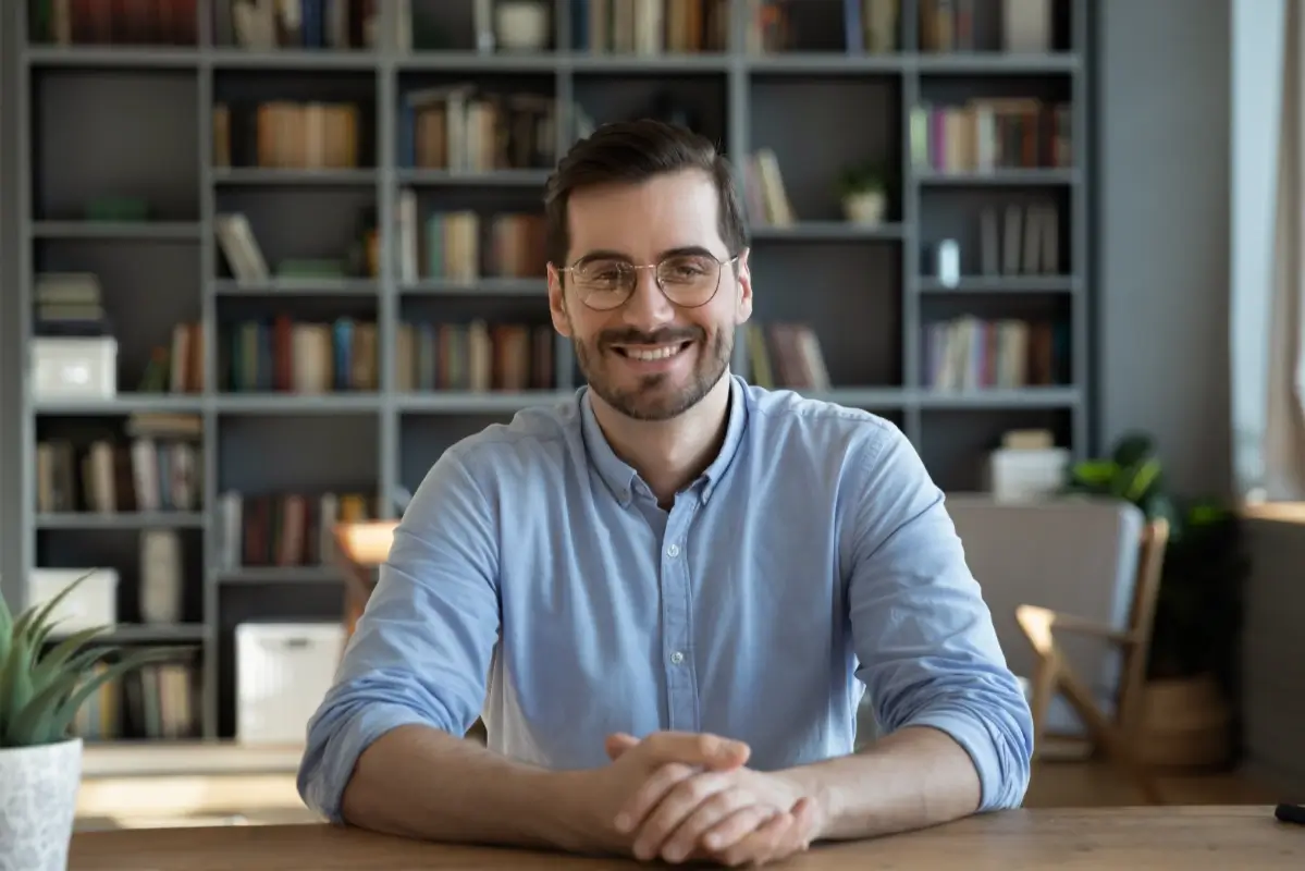 millenial man with glasses smiling