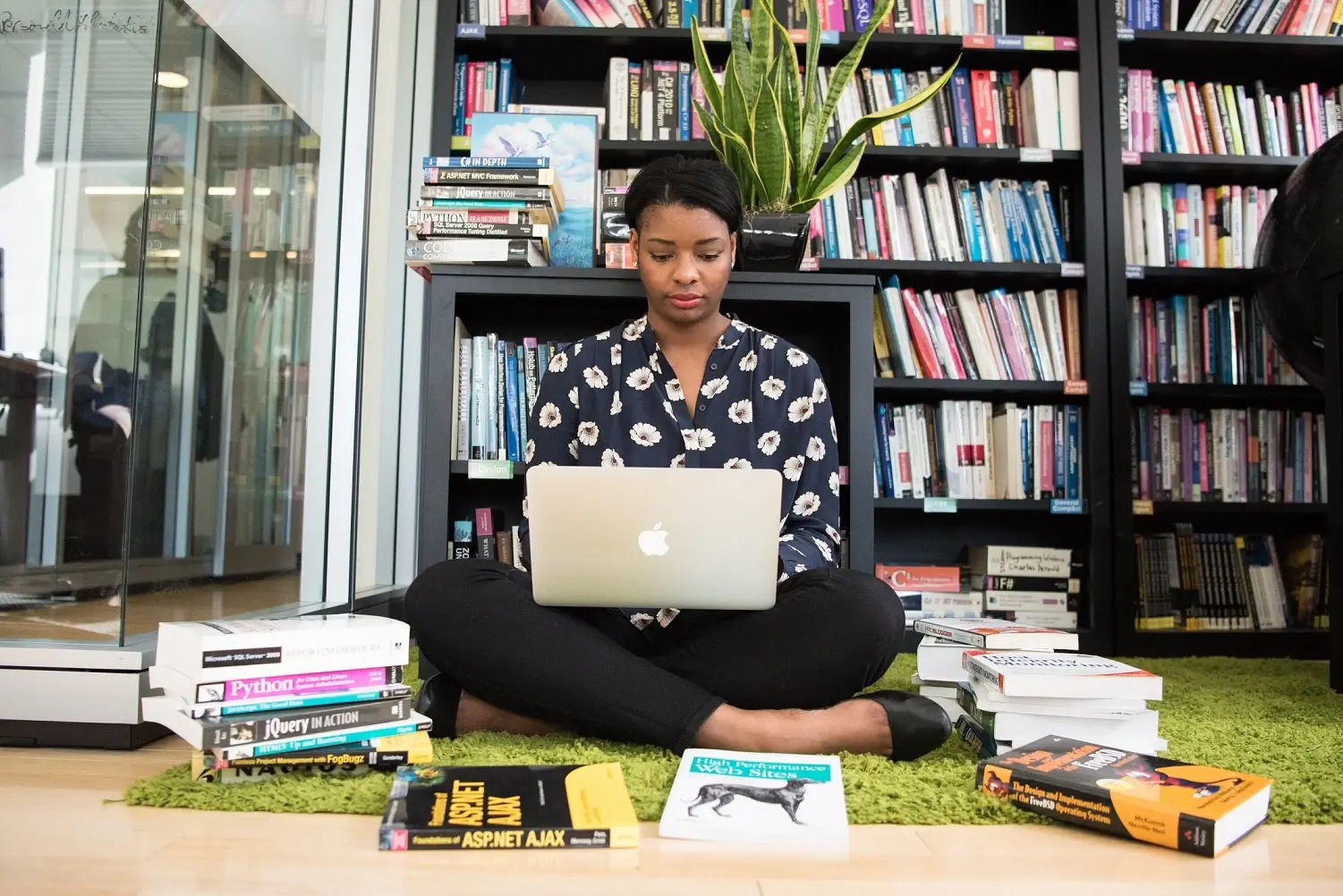 black-woman-sitting-on-the-floor-with-a-laptop