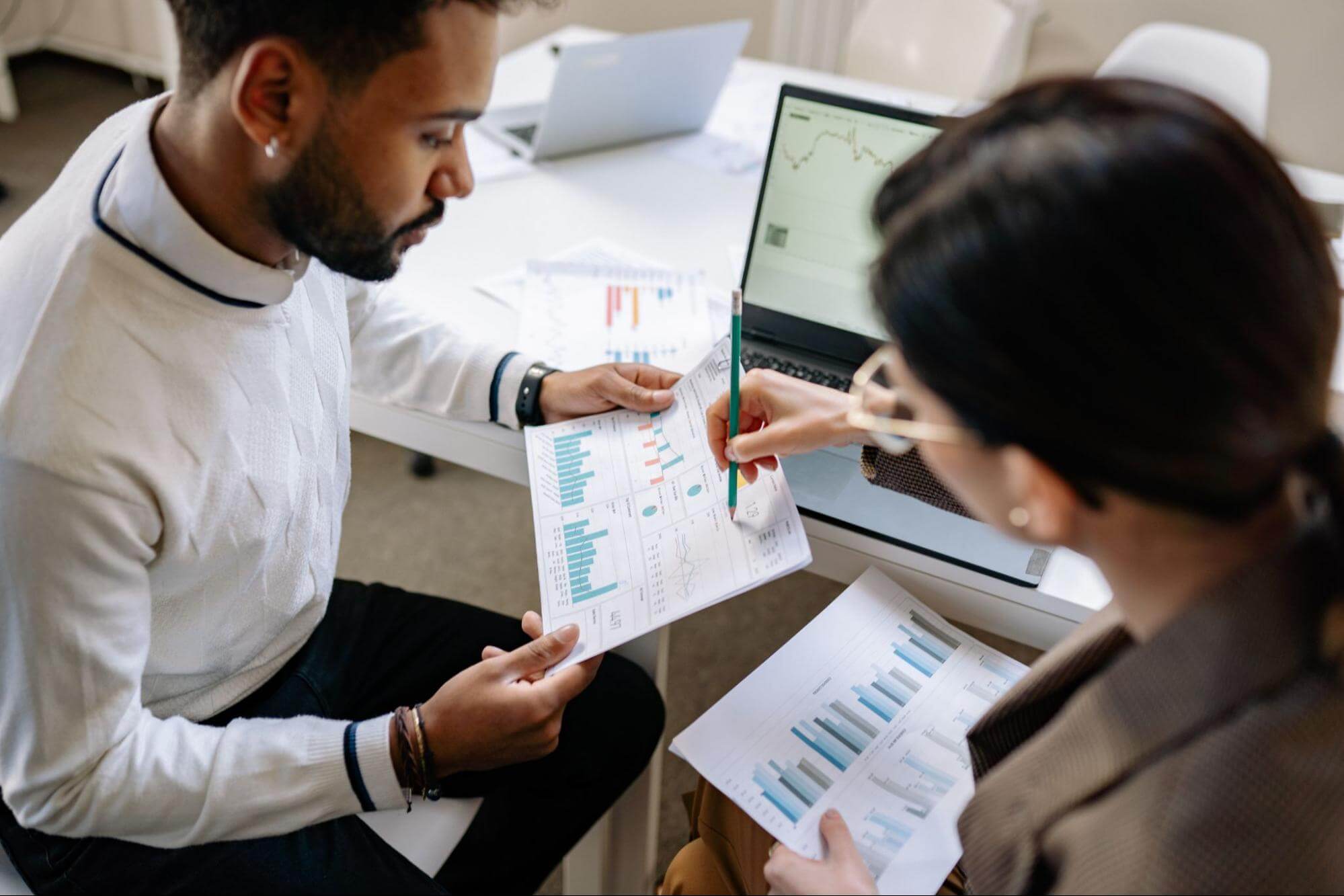 male and female employees analyzing data