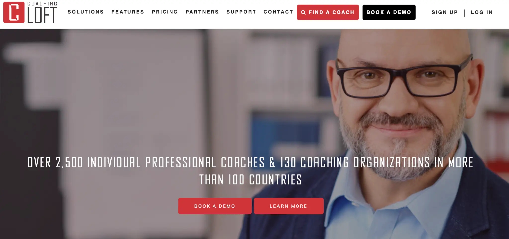 a screenshot of Coaching Loft Homepage showing a man in eyeglasses smiling at the camera