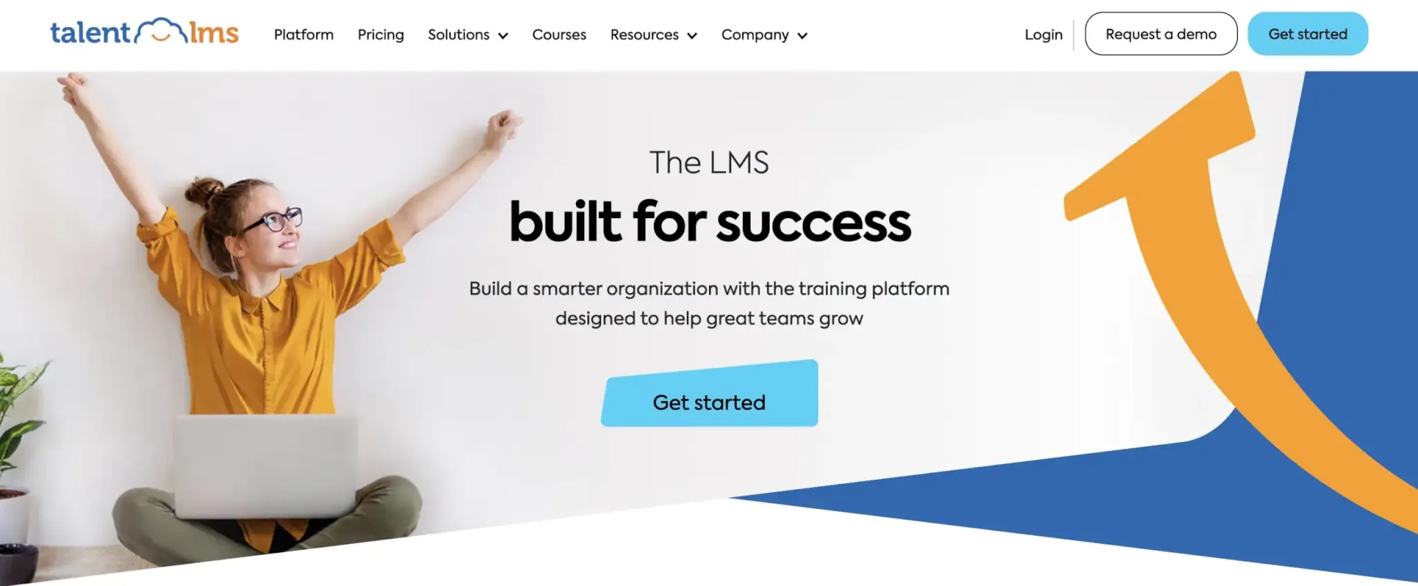 an image of the TalentLMS landing page showing a young woman in orange shirt smiling with her hands stretched out