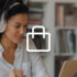 A woman wearing white headphones is looking at a laptop screen.