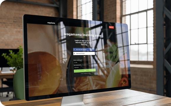 Desktop monitor displaying the Wagamama Learning Zone login page.