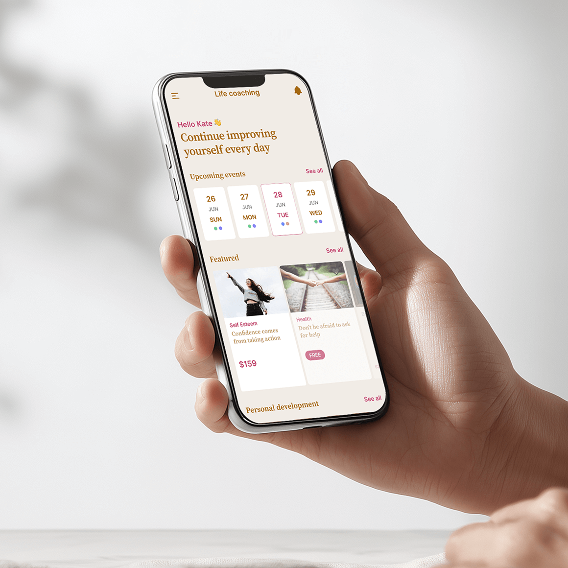 An image of a hand holding a mobile showing a course page on screen.
