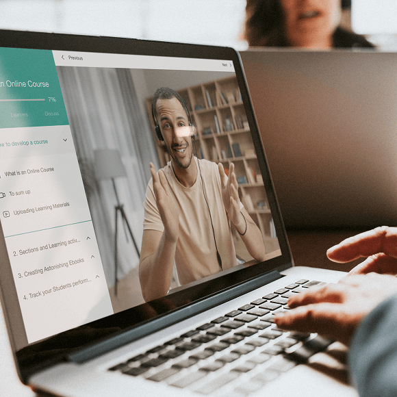 A man inside a macbook showing interactive video content from a course