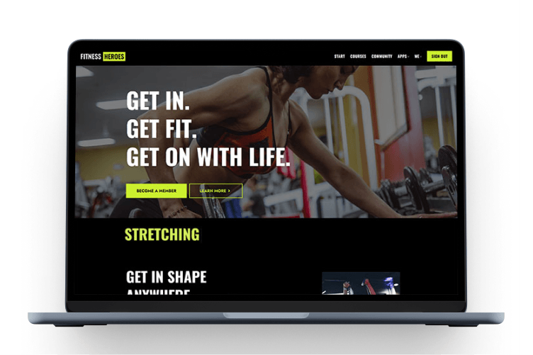 Laptop showing a fitness training page on screen.