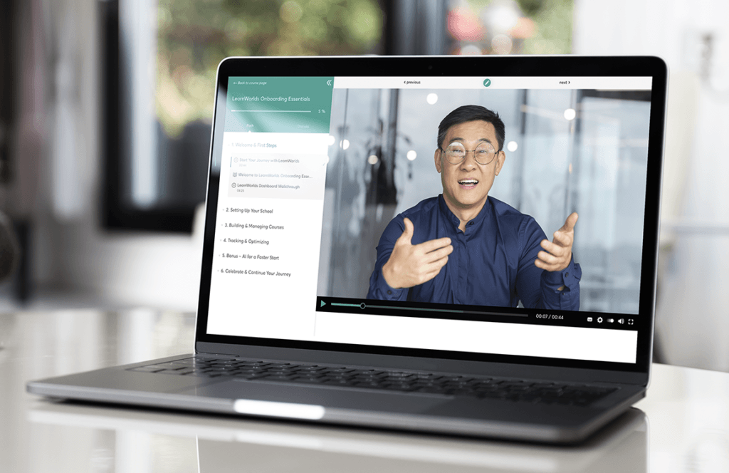 Laptop displaying a video lesson with an instructor speaking on screen.