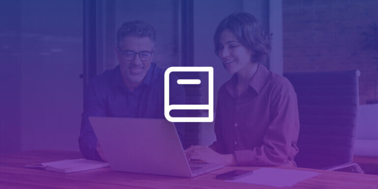 Two professionals collaborating on a laptop, representing a customer education program in action
