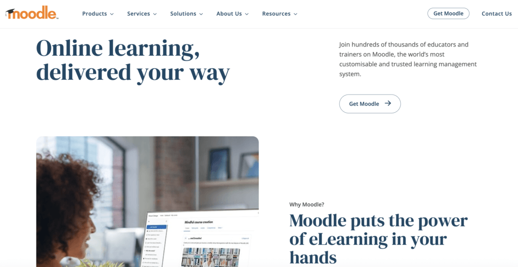 moodle homepage with woman watching something on laptop
