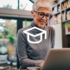 A woman working on a laptop, representing customer education in SaaS