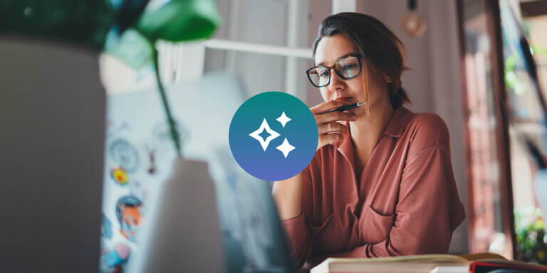 An image showing a woman looking at a laptop screen with an AI icon in a blue-green circle in front of her.